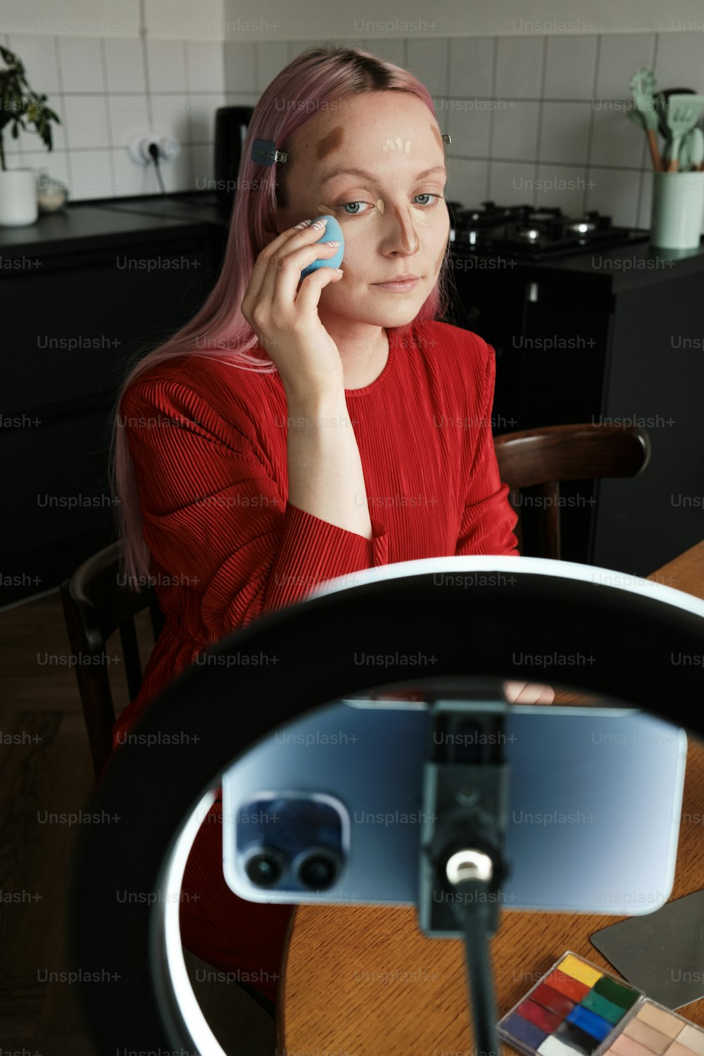a woman sitting at a table talking on a cell phone