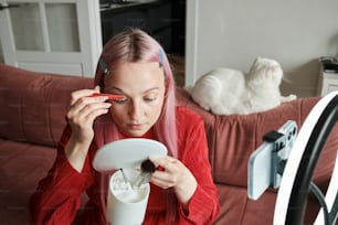 a woman sitting on a couch holding a cup of coffee