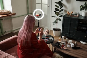 a woman sitting on a couch in front of a mirror