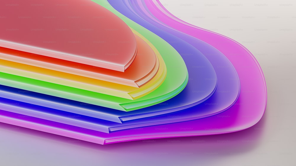 a stack of different colored papers on a white surface