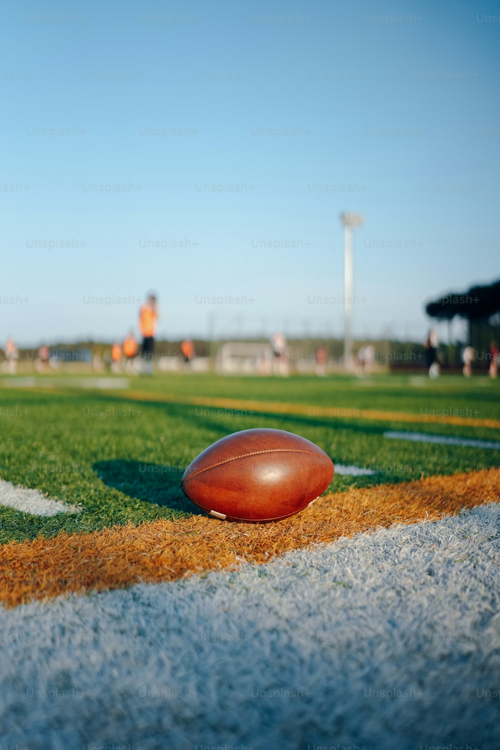 a football laying on the sideline of a football field