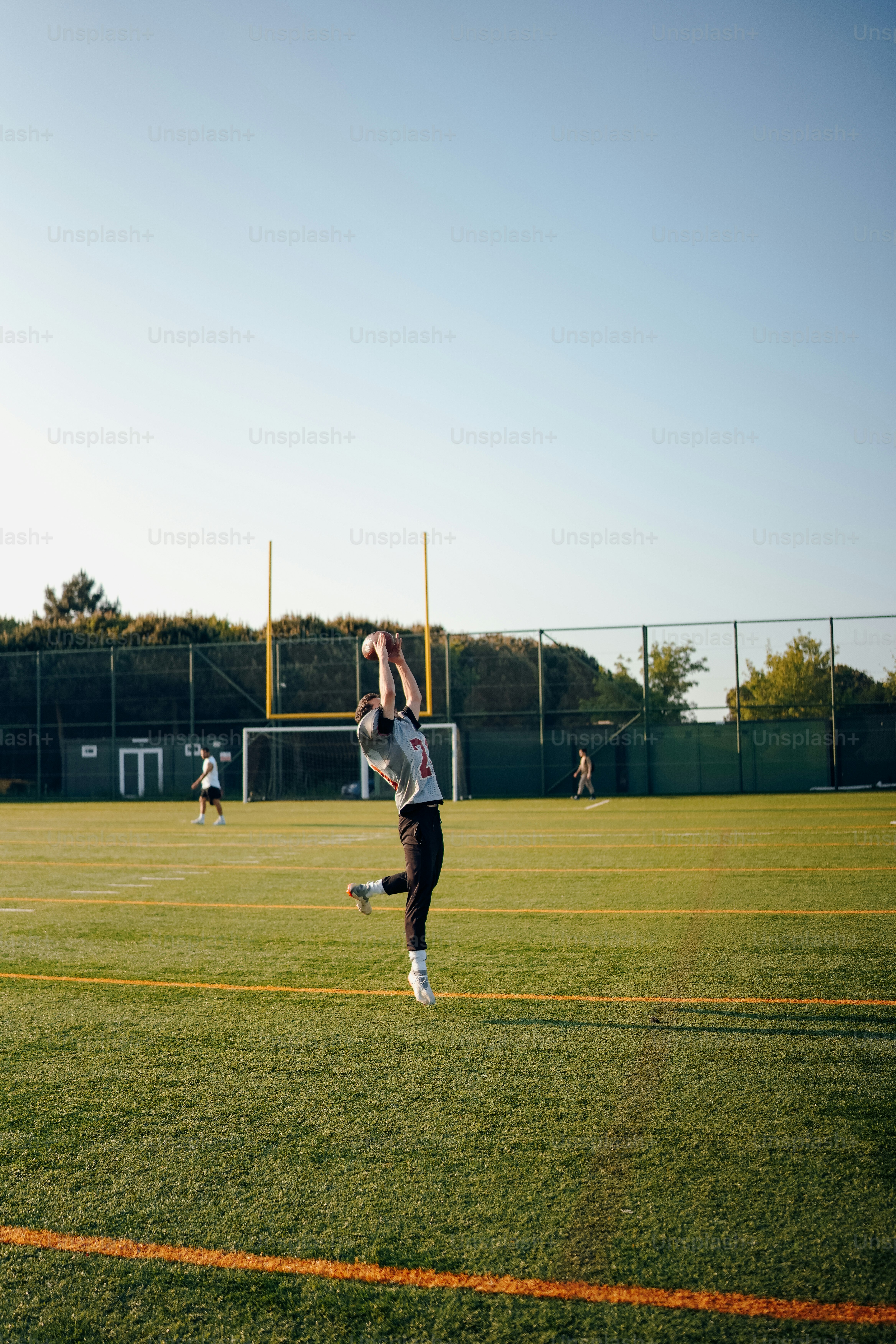 a person jumping in the air to catch a frisbee