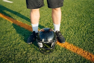 a football player with a helmet on the field