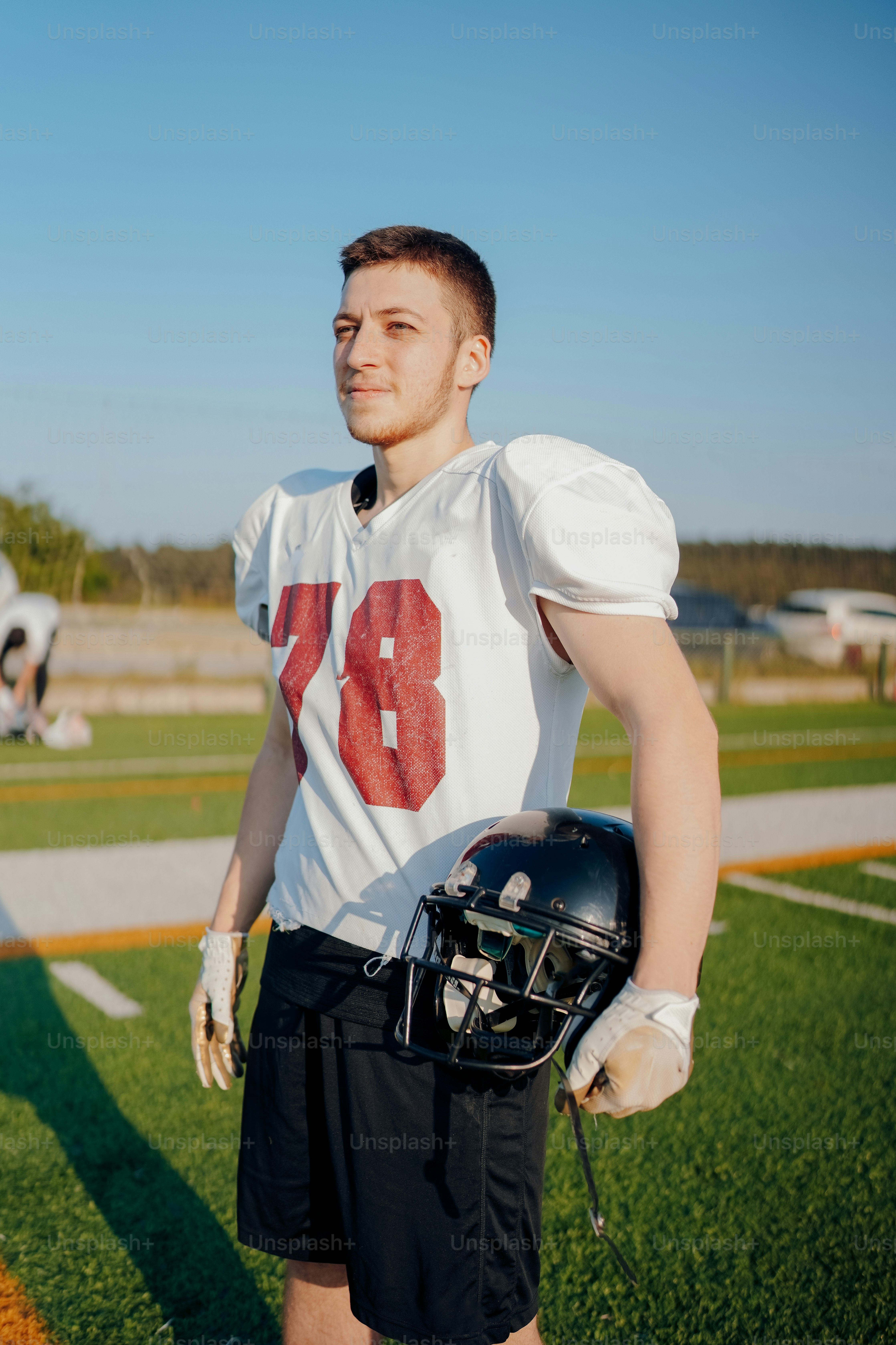 a man in a football uniform standing on a field