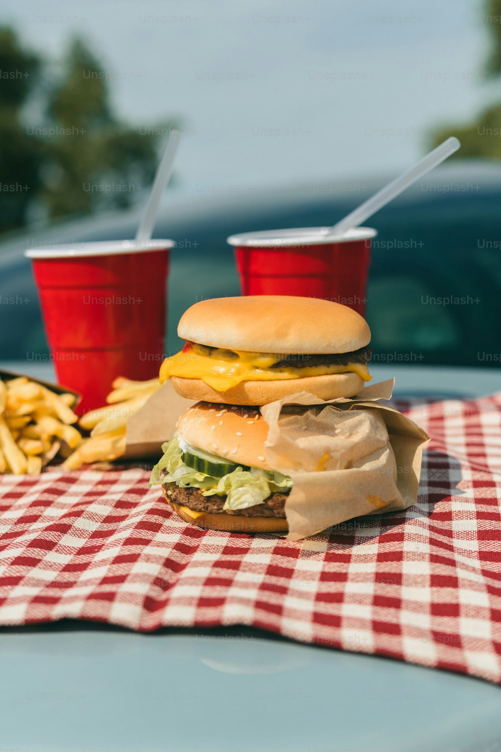 a hamburger and french fries on a picnic table