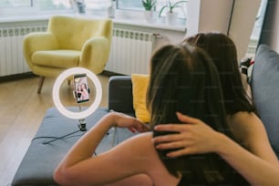 Une femme assise sur un canapé devant un miroir