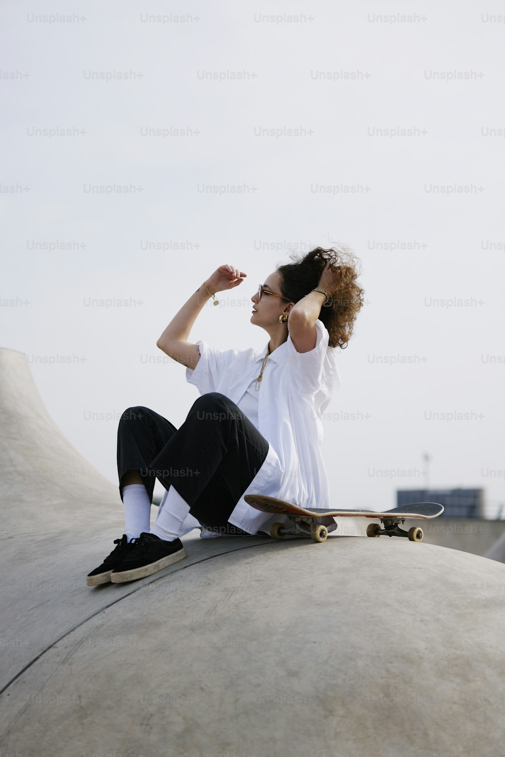 a woman sitting on top of a cement structure