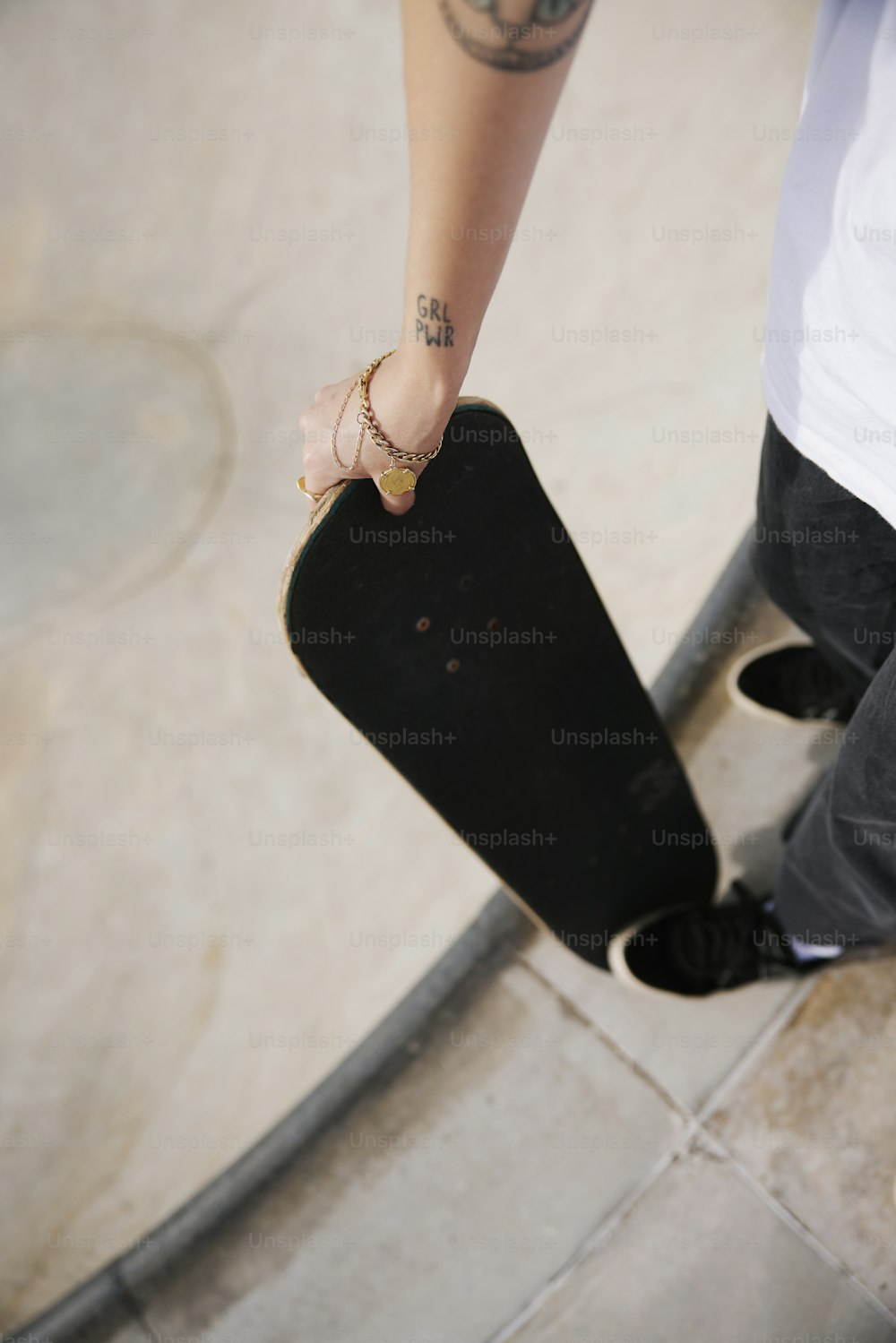 a person holding a skateboard in their hand