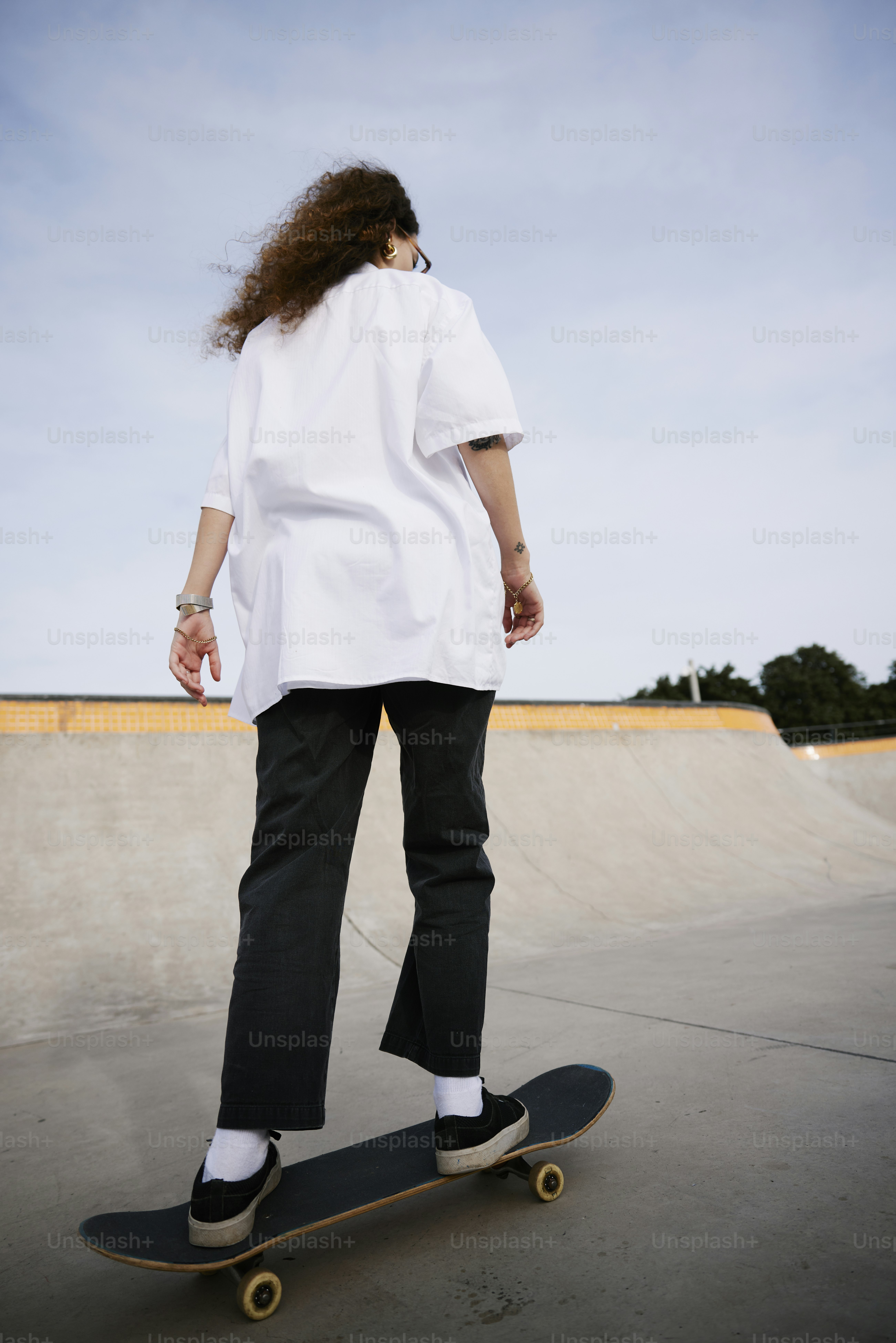 a person riding a skateboard on a cement surface