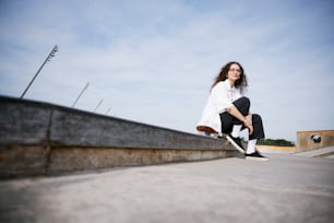 a young woman riding a skateboard down a cement ramp