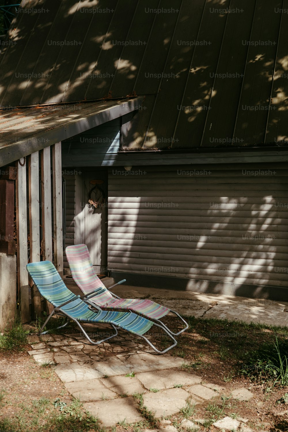 a lawn chair sitting in front of a garage