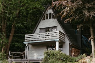 a small house with a balcony and a deck