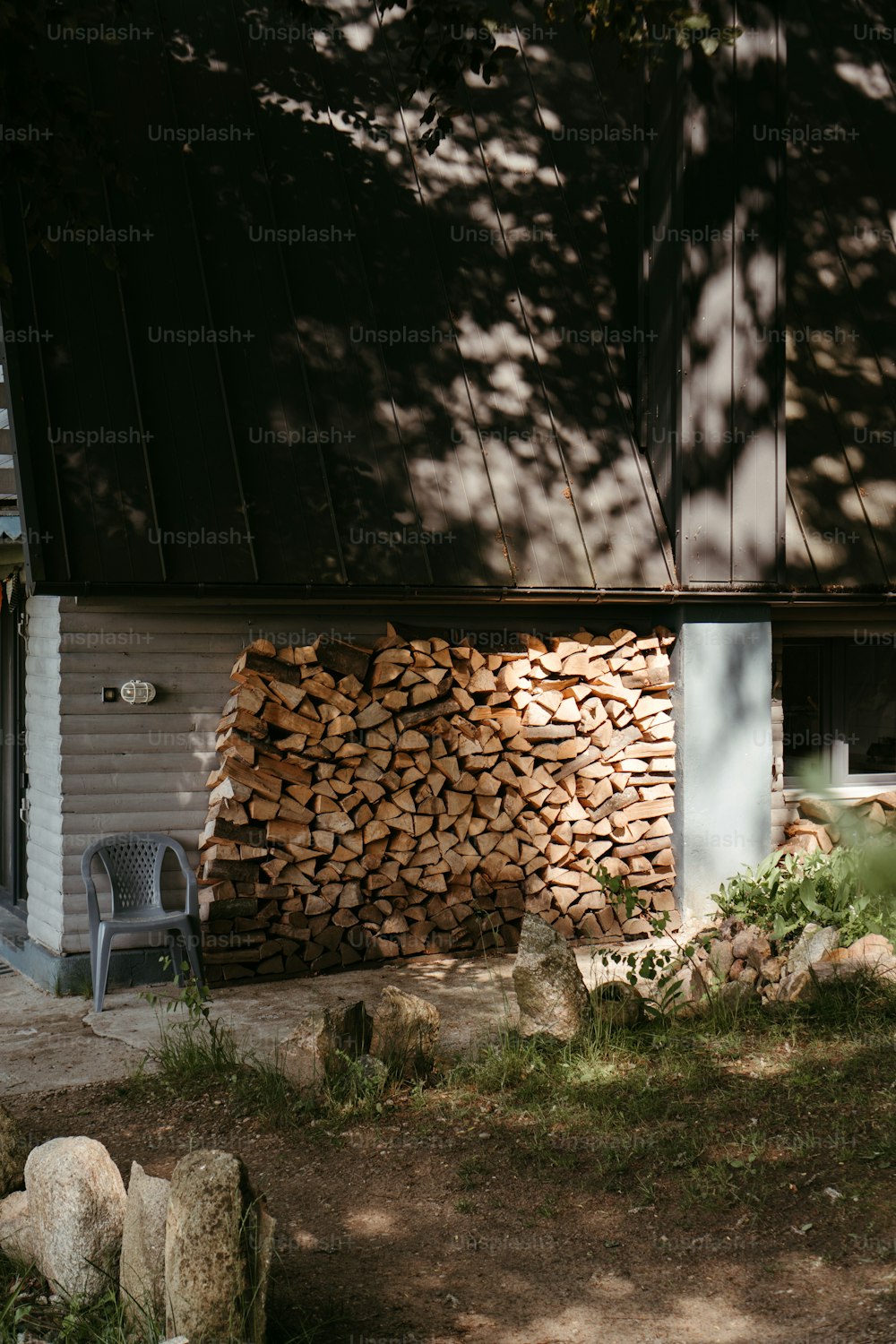 a pile of wood sitting next to a building