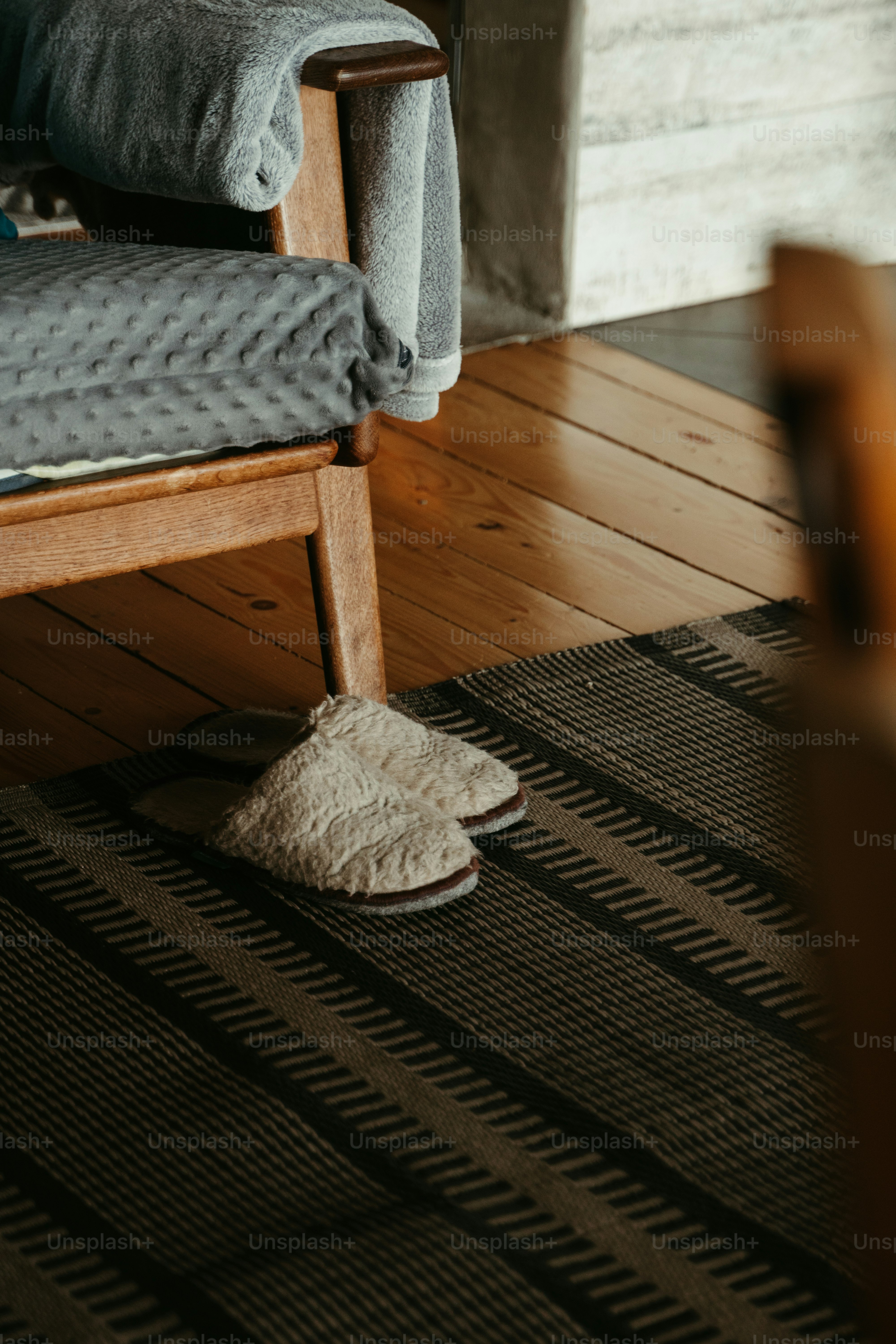 a pair of slippers sitting on top of a wooden floor