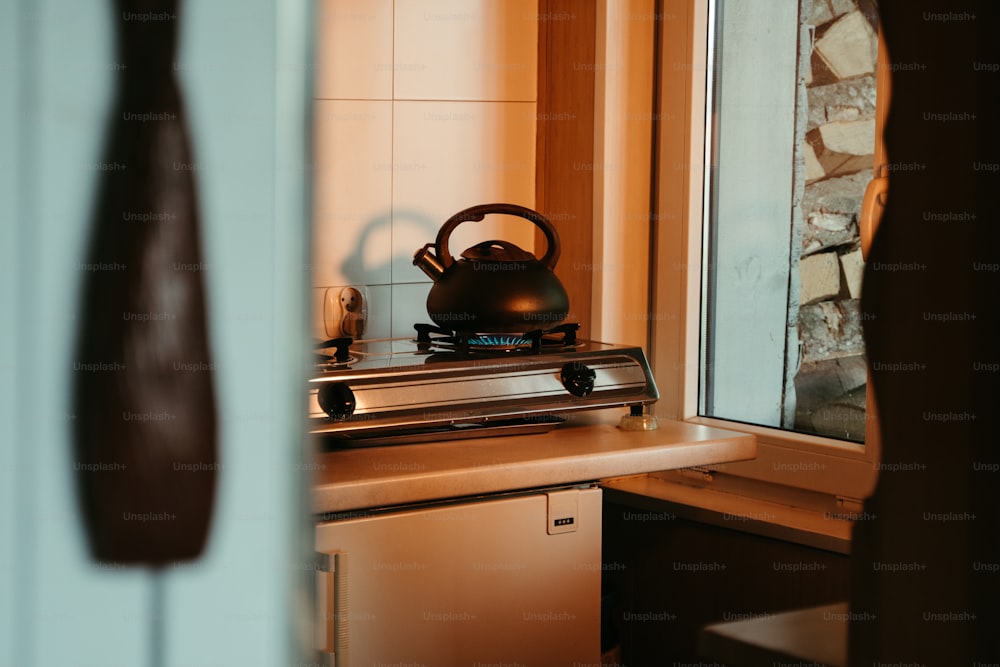 a tea kettle sitting on top of a stove