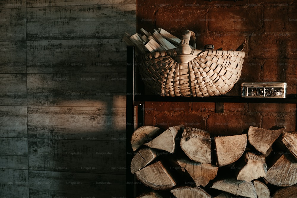 a stack of logs sitting next to a basket on top of a shelf