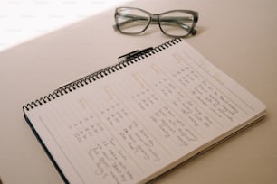 a calendar with glasses on a table next to a pair of glasses