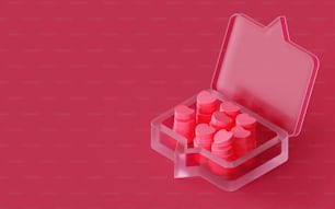 Ein rosafarbenes Etui gefüllt mit rosa Pillen auf rosa Hintergrund