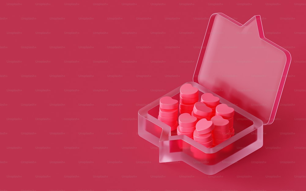 Un estuche rosa lleno de píldoras rosadas sobre un fondo rosa
