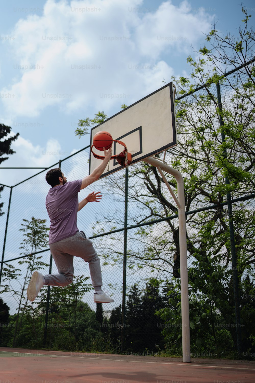 a man jumping up into the air to dunk a basketball