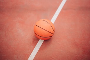 a basketball sitting on a court with a white line