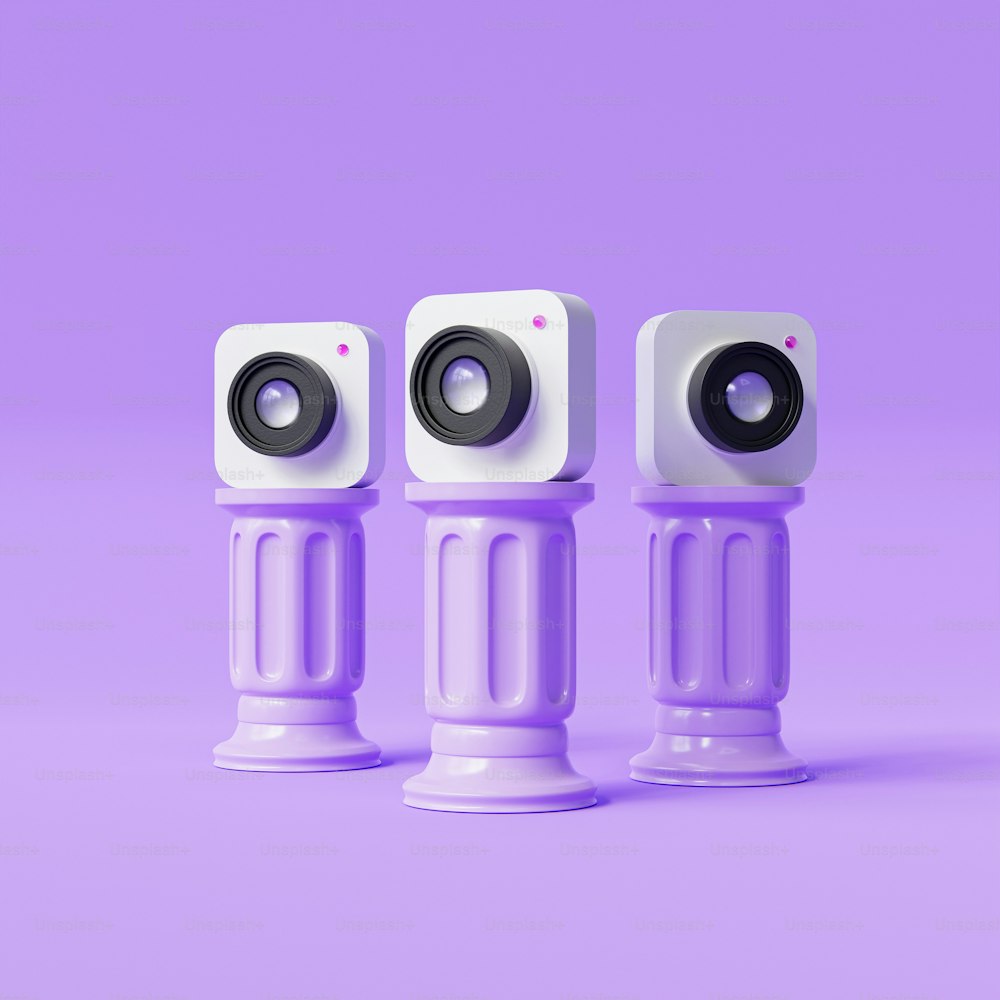 three small white speakers sitting on top of each other