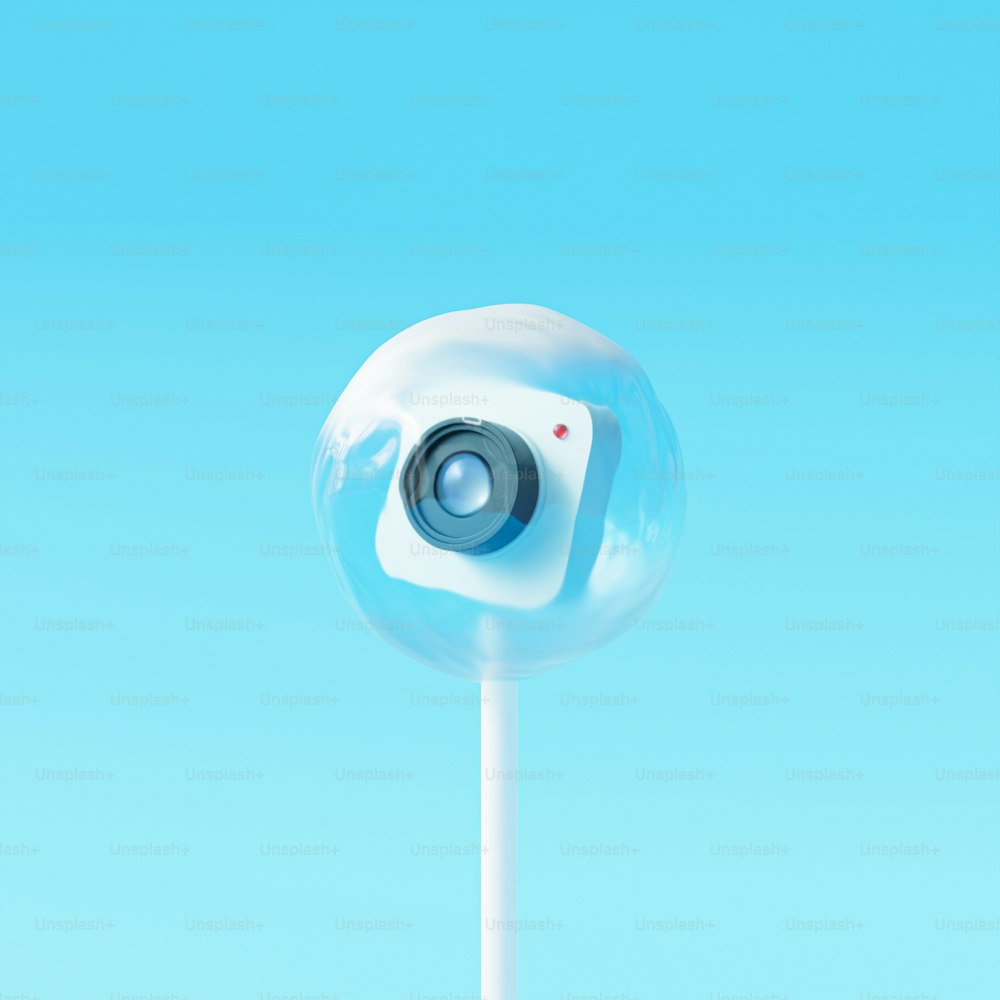 a blue and white object with a camera on top of it