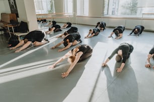 a group of people doing yoga in a room