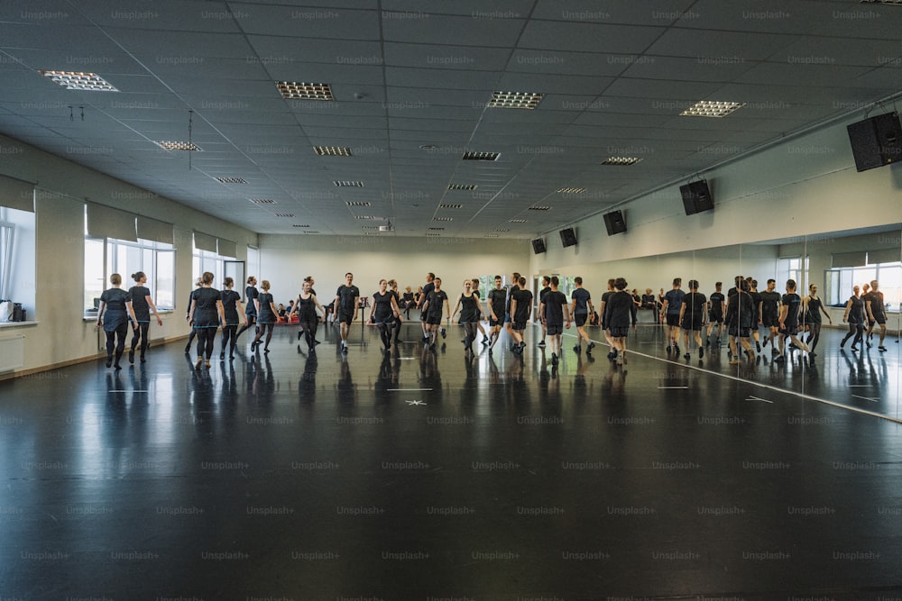 a large group of people walking in a large room