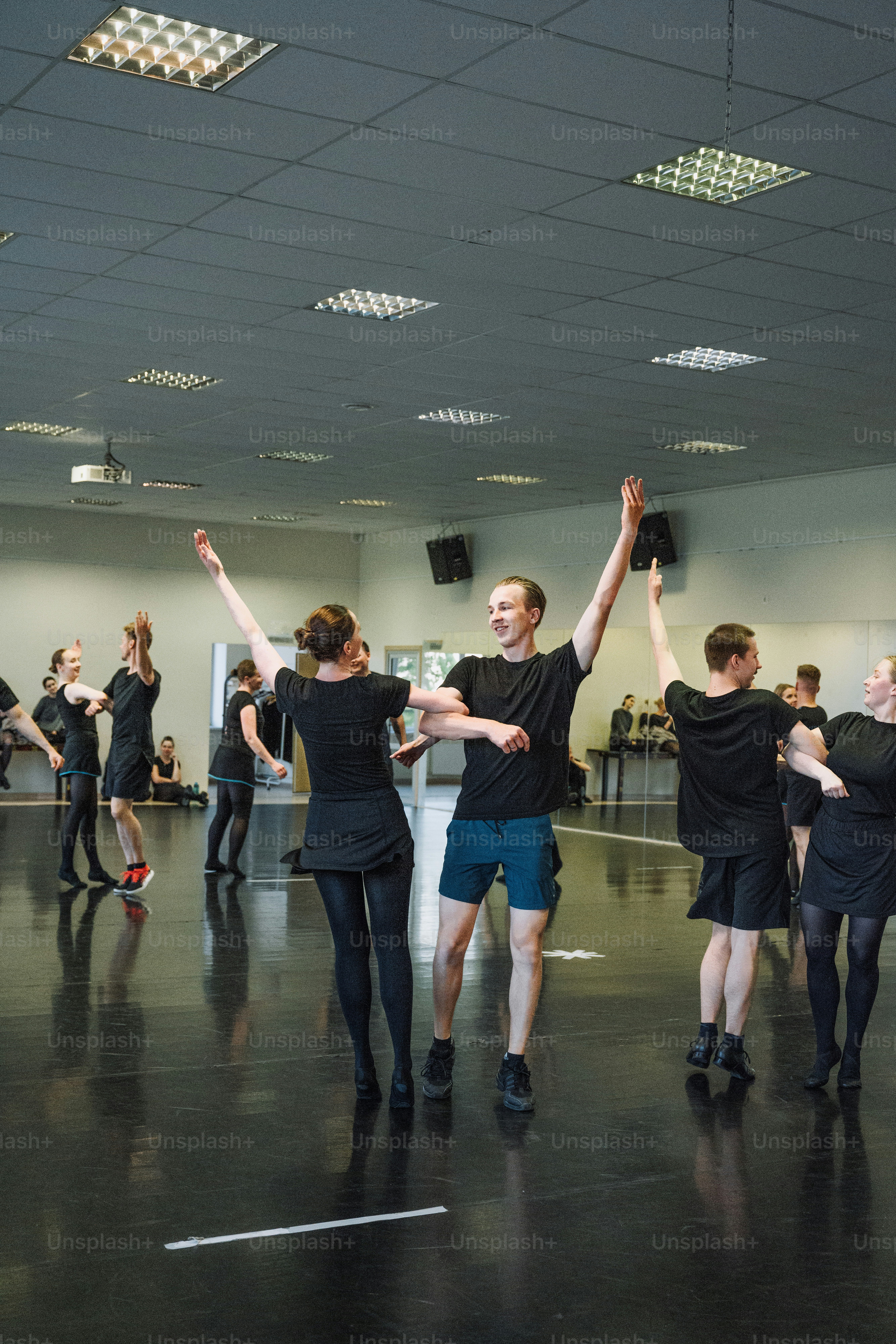 a group of people standing around each other in a room