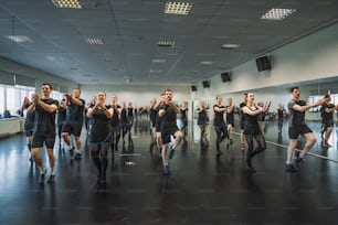 a group of people dancing in a large room