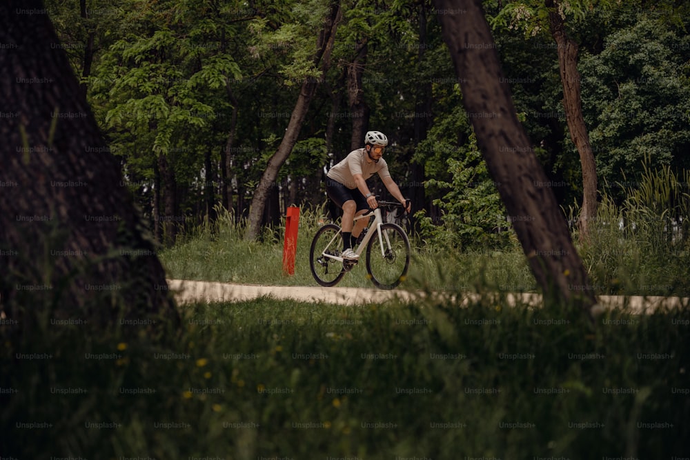 a man riding a bike through a forest