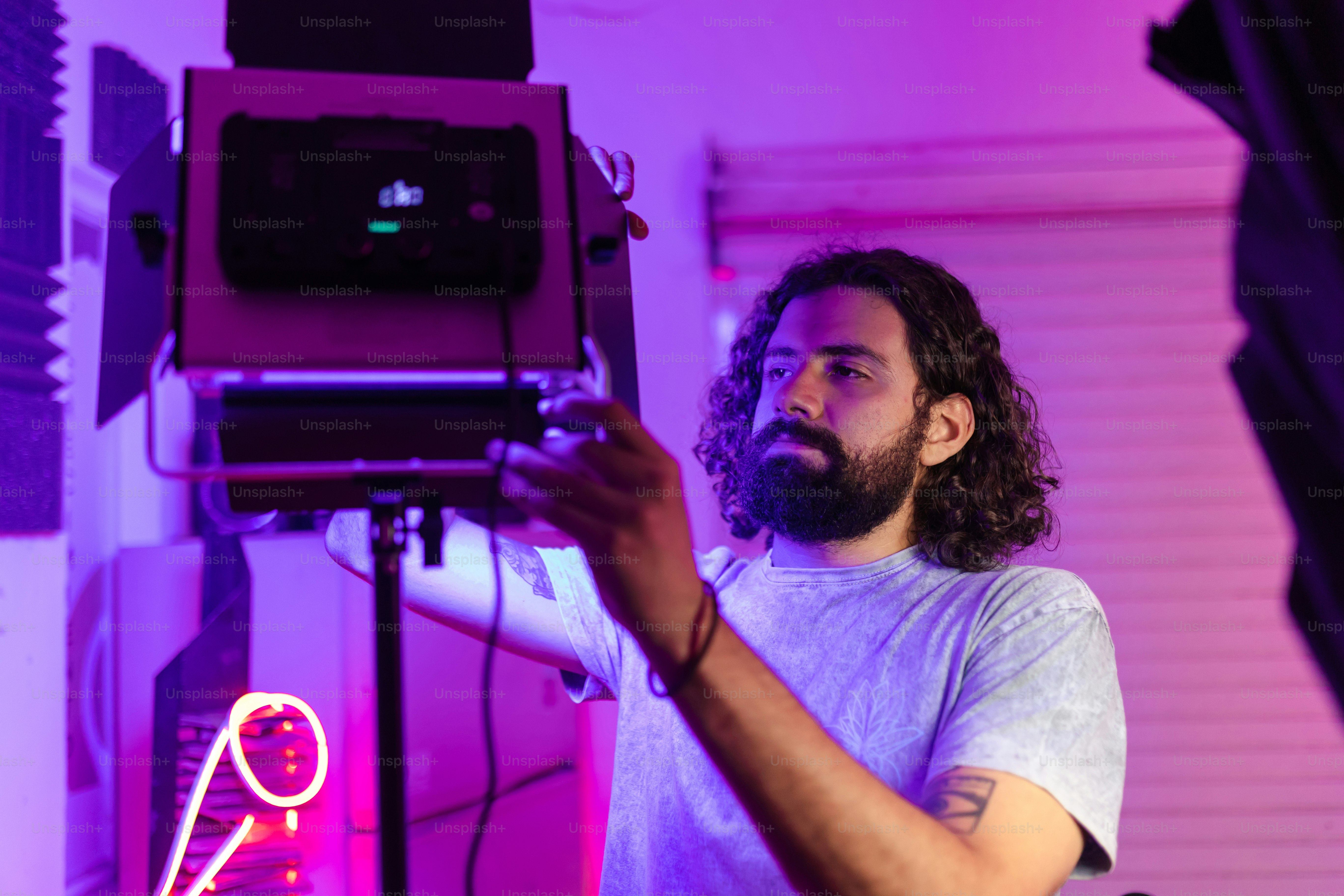 a man with a beard is holding a camera