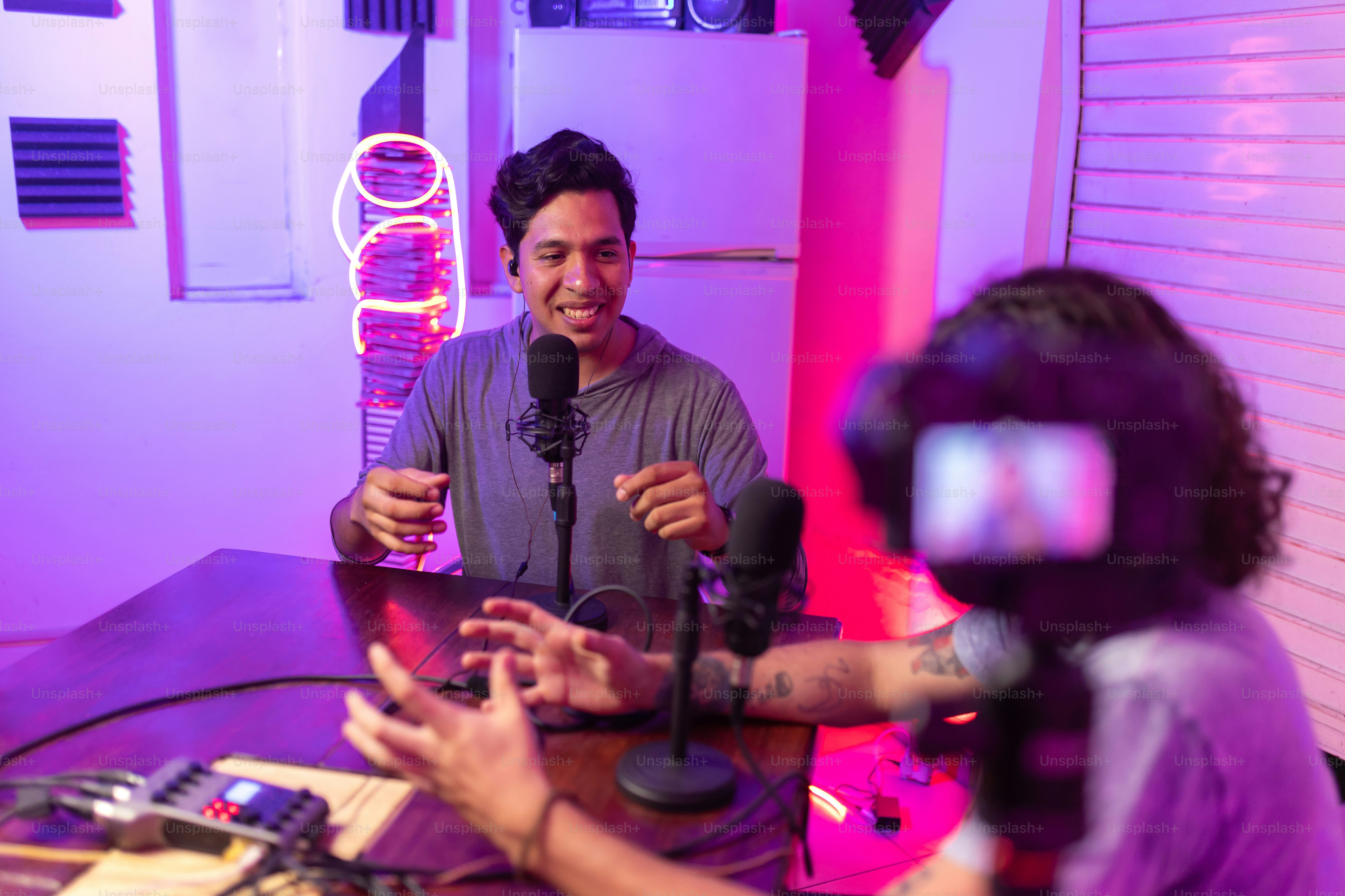 a man sitting at a table with a microphone