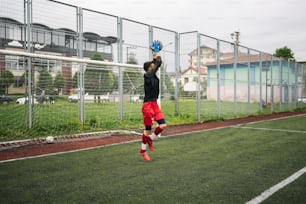 a person jumping in the air on a soccer field