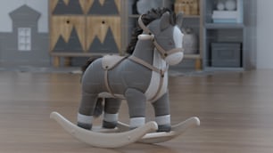 Un cavallo a dondolo giocattolo su un pavimento di legno