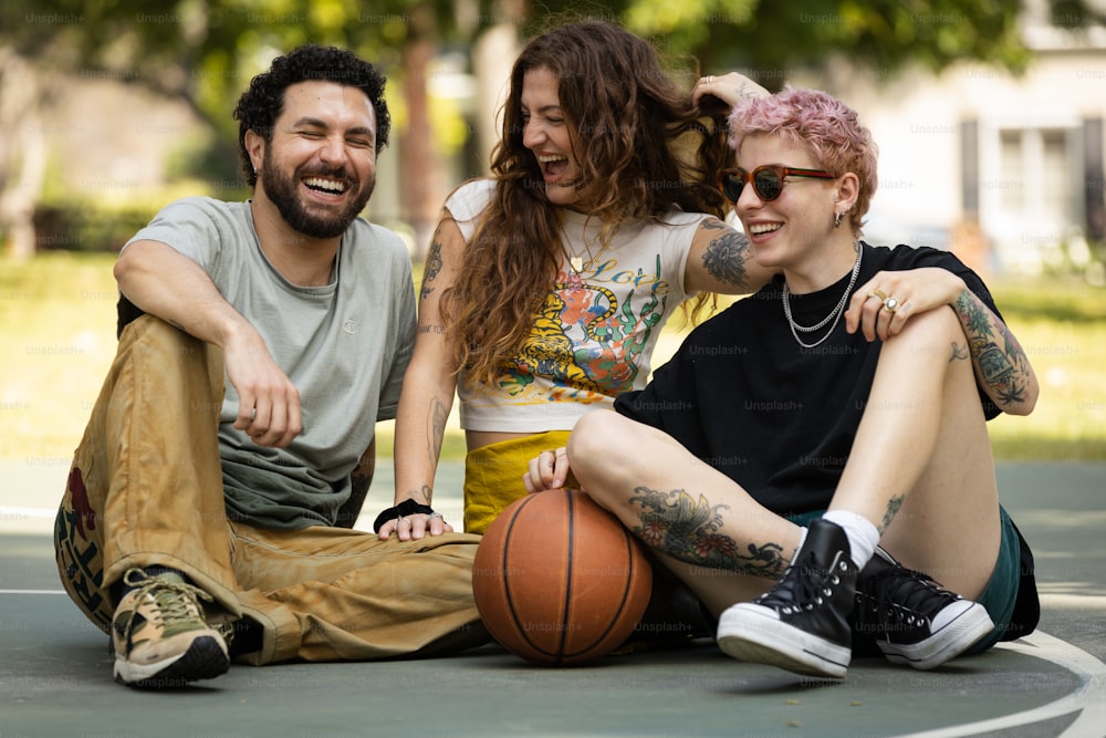 a couple of people that are sitting on a basketball court