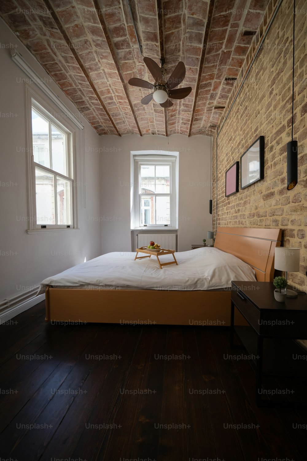 a bedroom with a bed and a ceiling fan