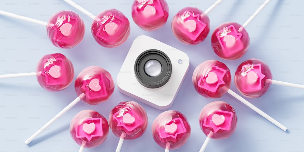 a camera surrounded by pink lollipops on a blue background