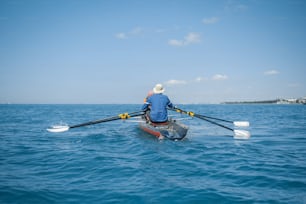 a man rowing a boat in the ocean
