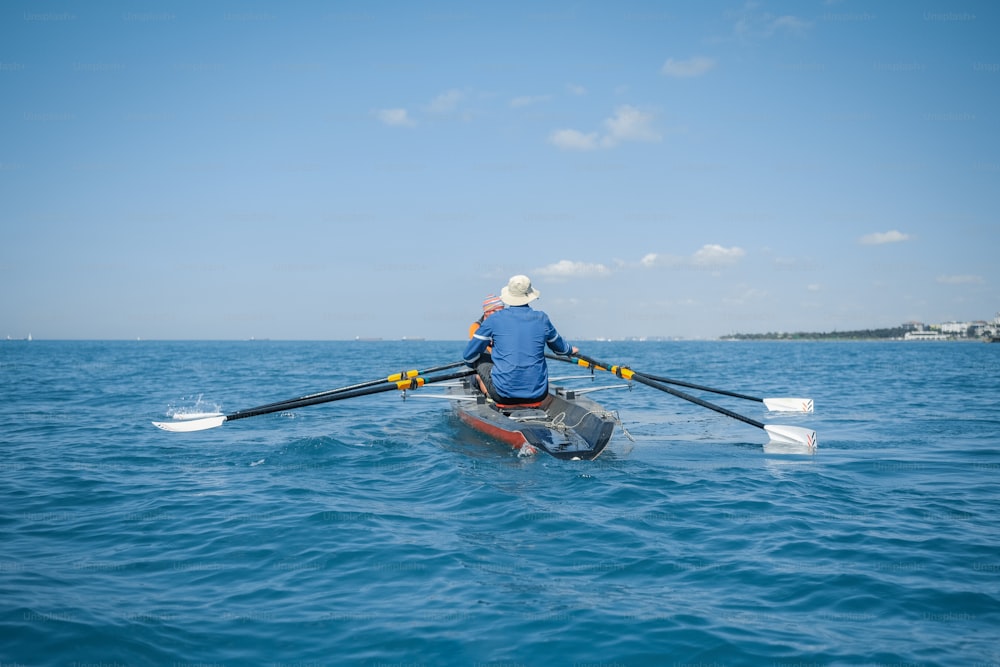 a man rowing a boat in the ocean