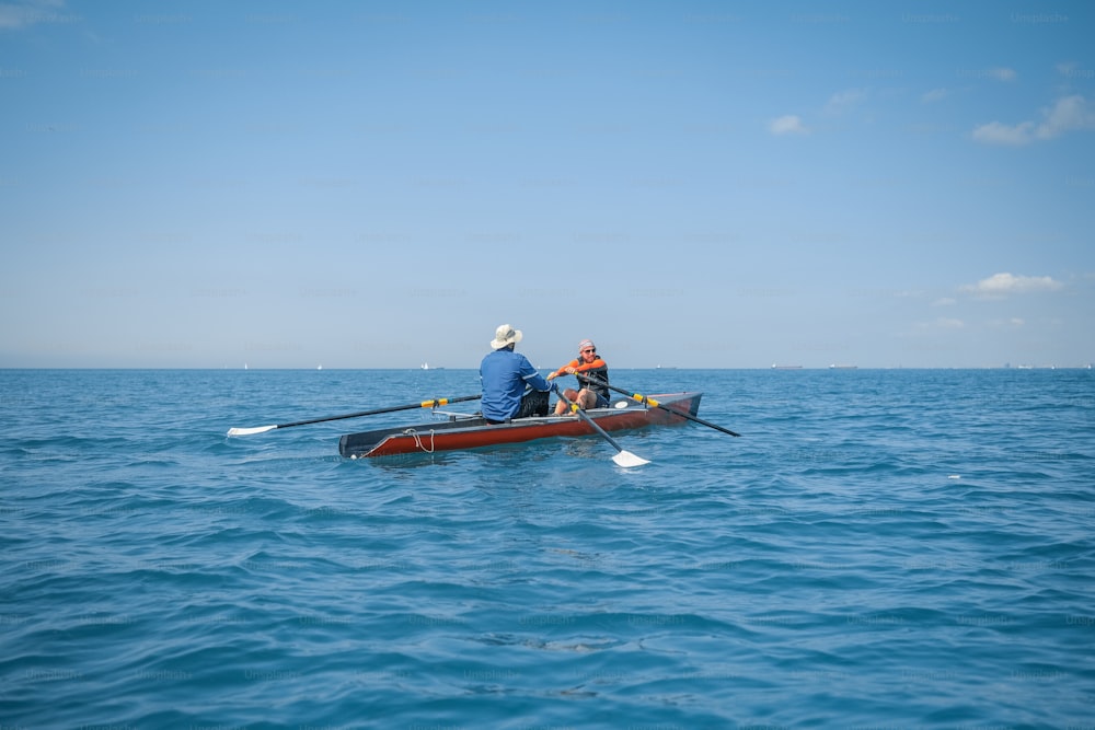 two people in a boat in the middle of the ocean