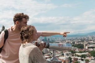 a man and a woman pointing at something in the distance