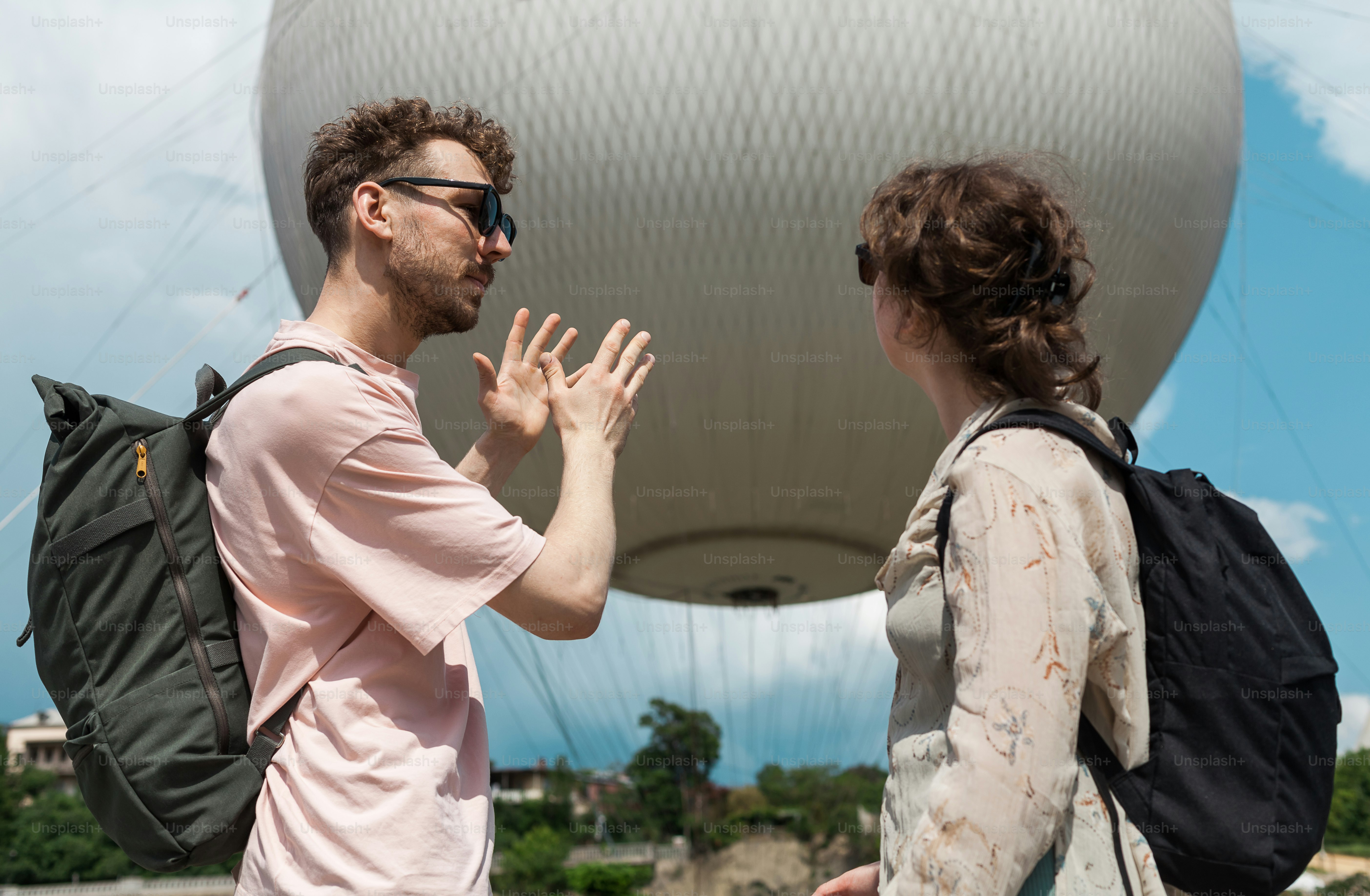 A man and a woman standing on top of a hill photo – Travel Image on ...