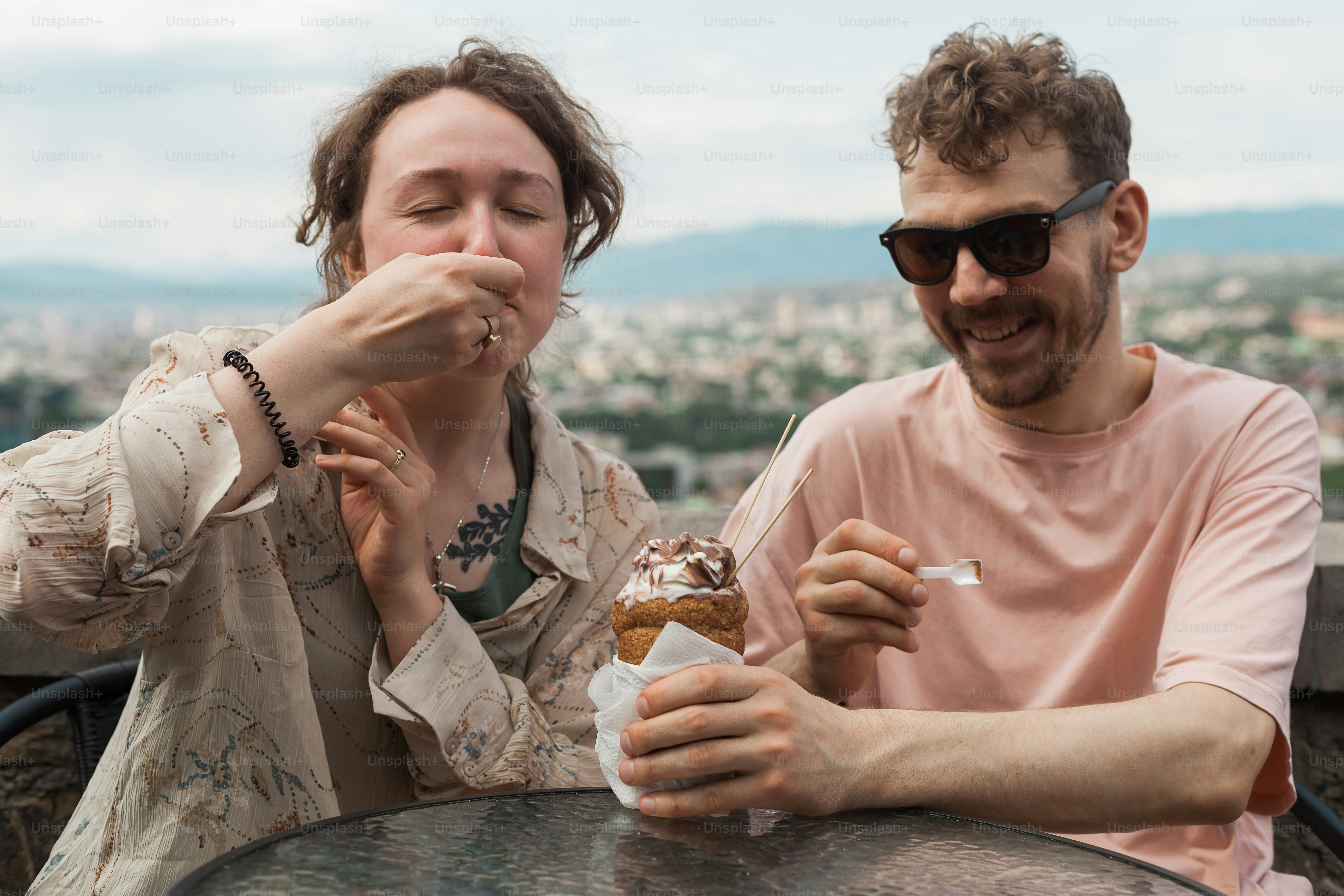 a man and a woman sitting at a table eating food
