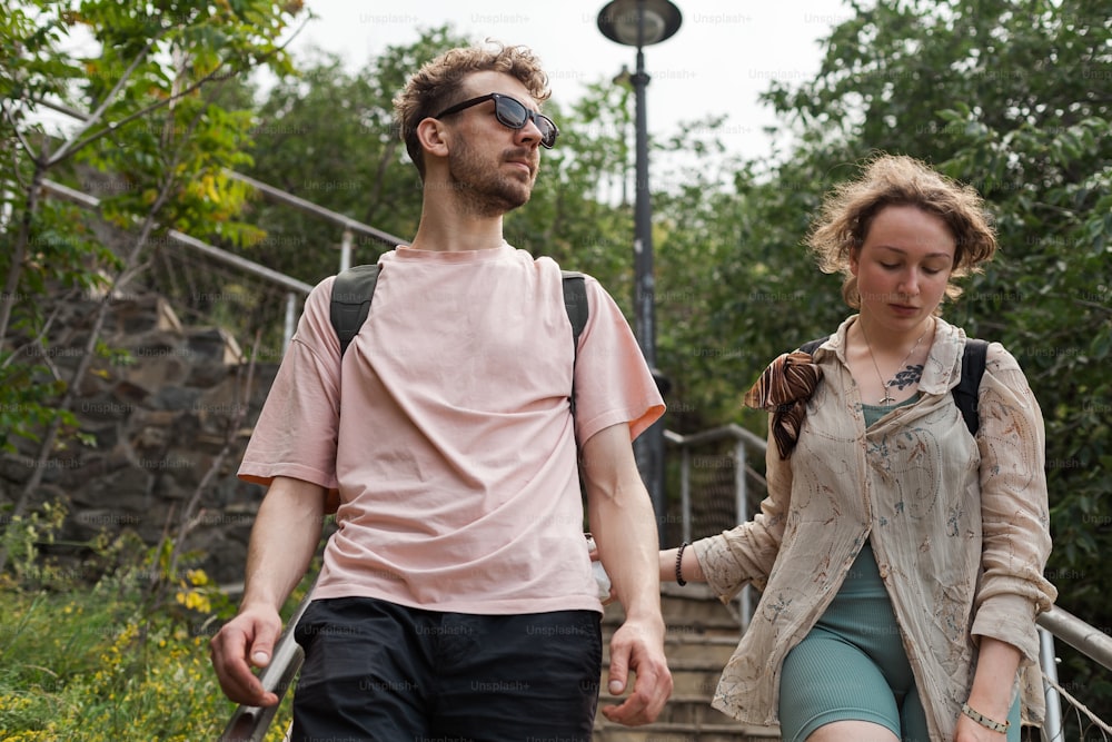 a man and a woman walking down a flight of stairs