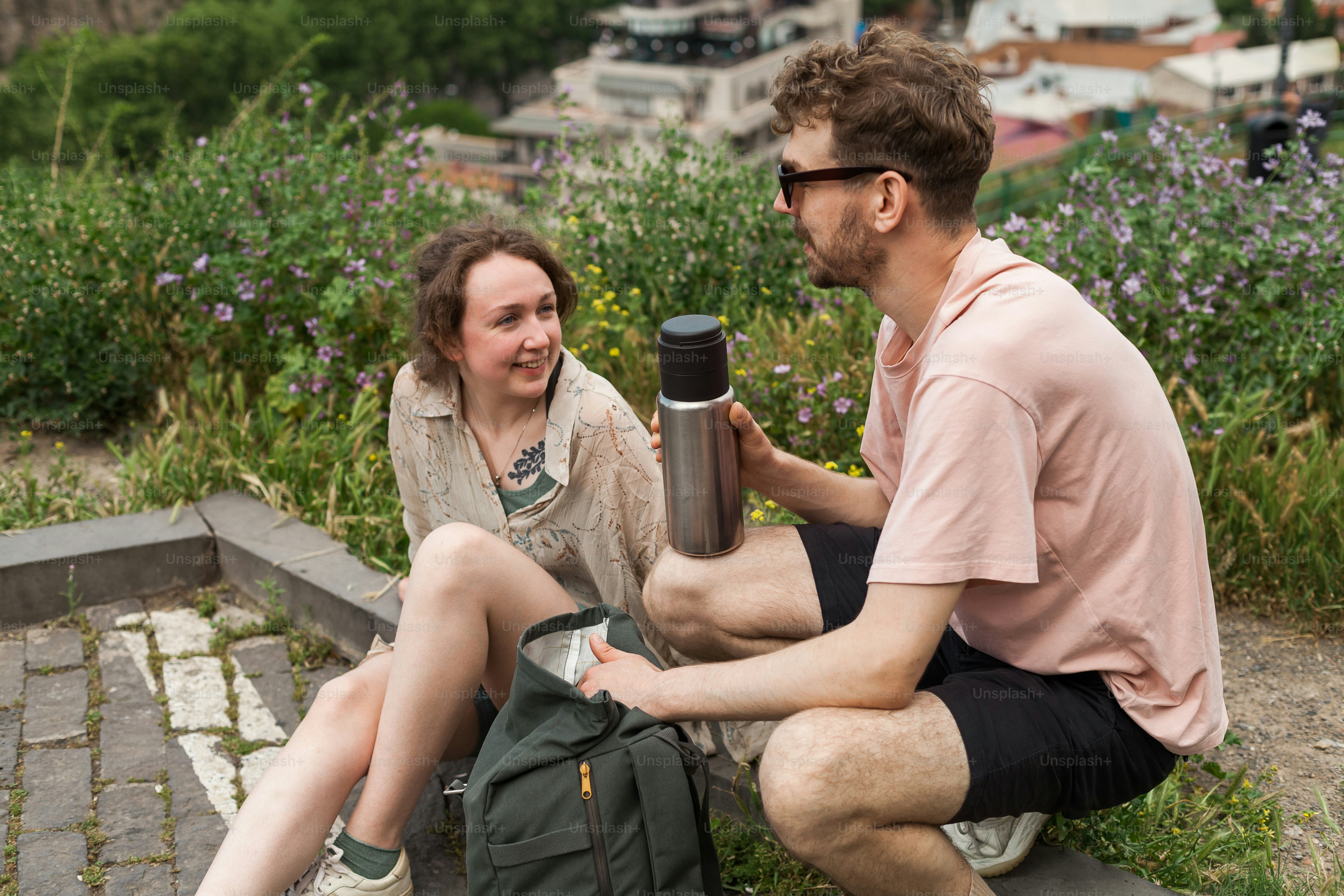 A man and a woman standing on top of a hill photo – Travel Image on ...