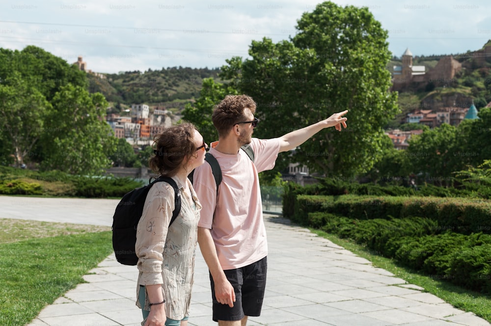 a man and a woman are pointing at something