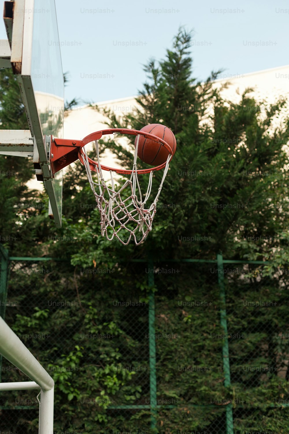 a basketball going through the net of a basketball hoop