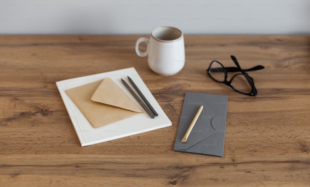 a desk with a notepad, pen, and glasses on it